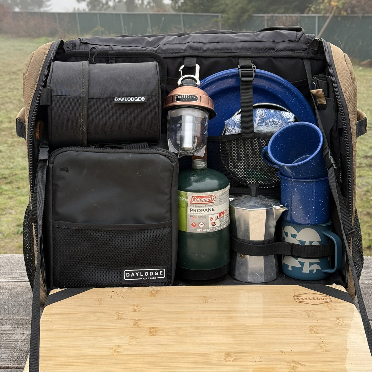 Workspace Camp Collection packed with the Cold Cube, lantern, propane, enamel plates and mugs, and a moka pot