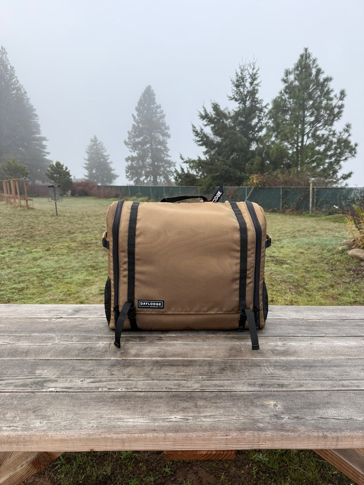 Workspace Camp Kitchen bag closed on a picnic table on a foggy morning