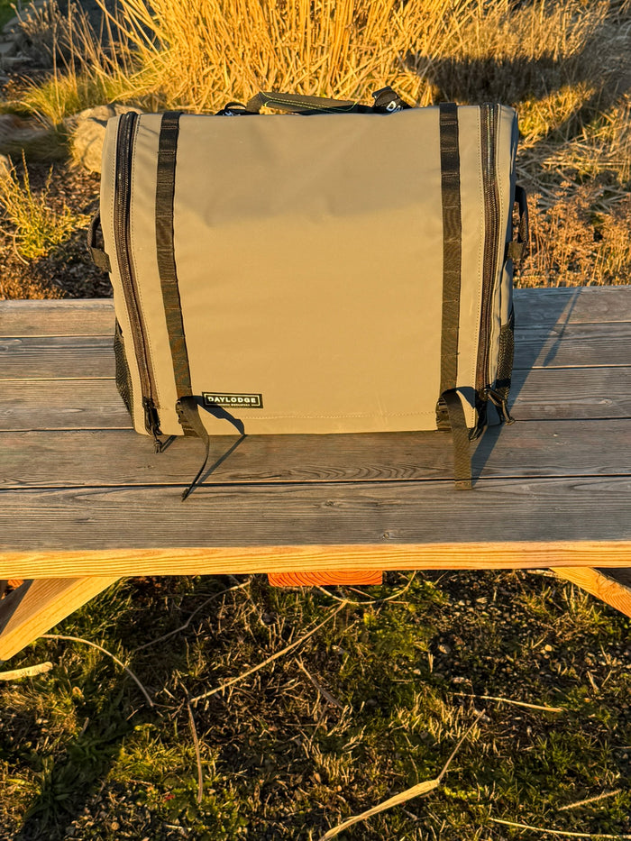 Workspace packed and closed on a picnic table at golden hour