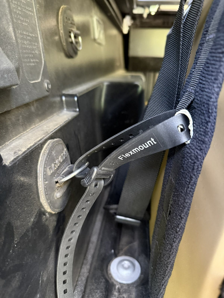 FlexMount rubber strap through a truck bed tie-down