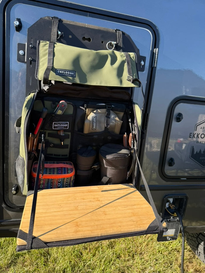 Workspace hanging open from a MOLLE panel on an RV door