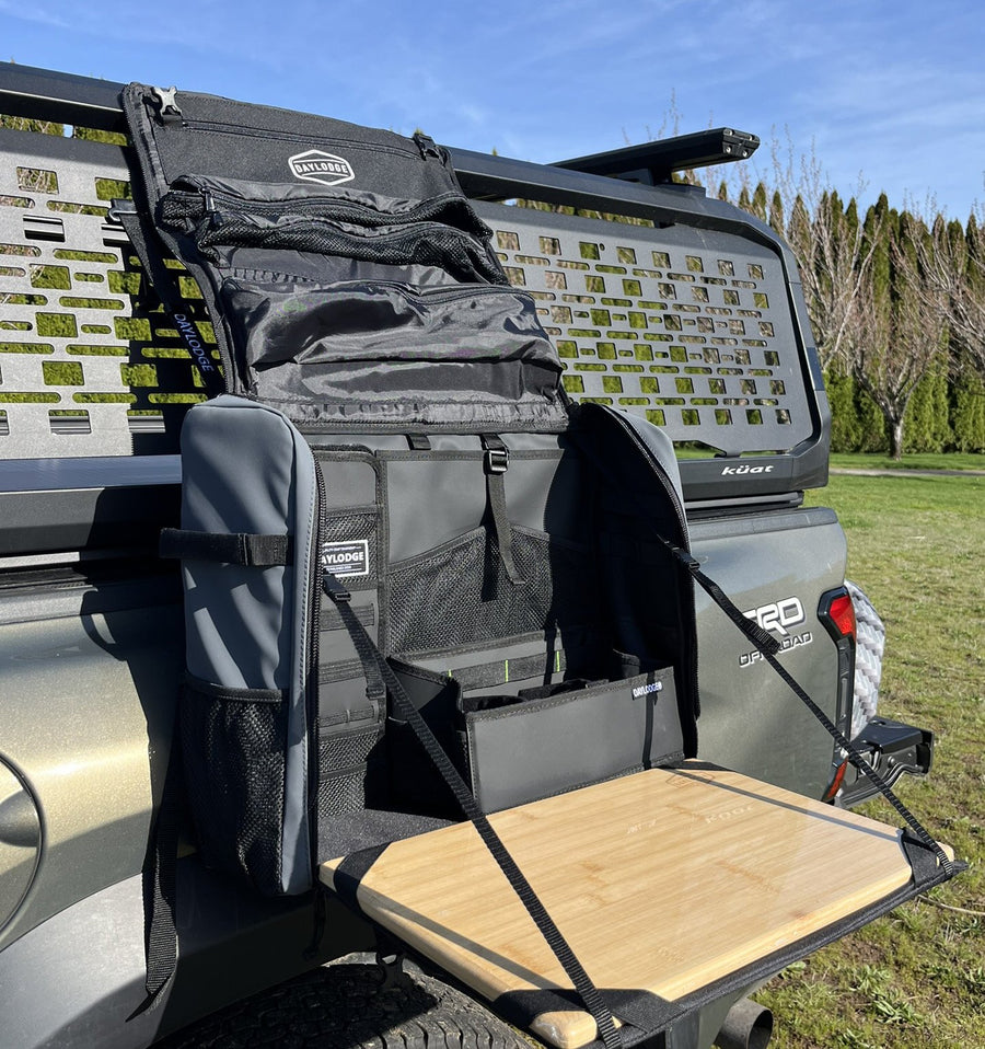 Workspace mounted on a MOLLE plate on a truck bed rack, bamboo board open