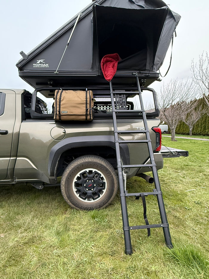 Workspace hanging from the bed rack under a roof-top tent on a Toyota Tacoma