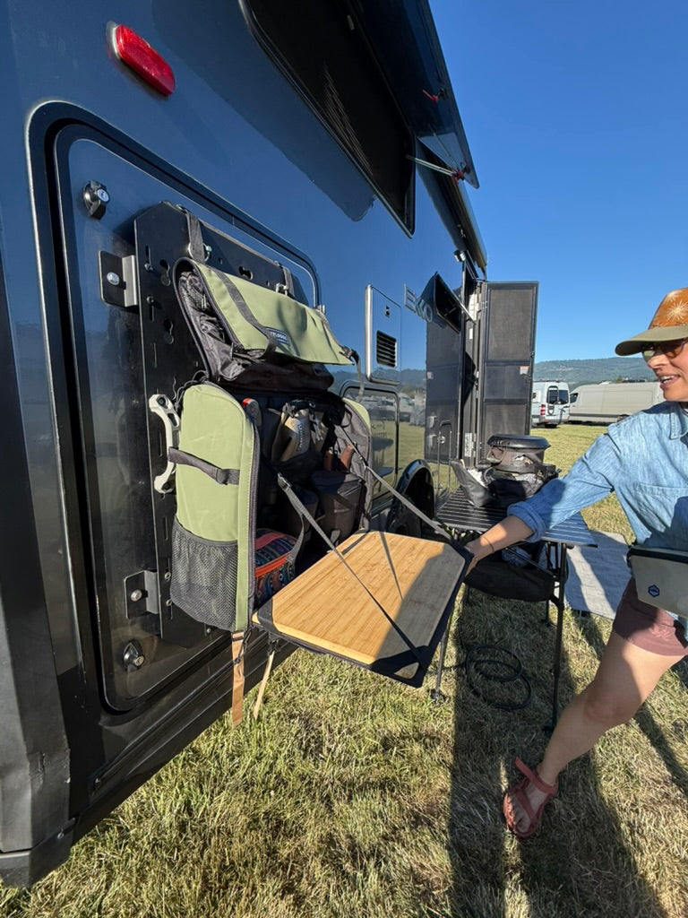 Workspace hanging open from a MOLLE panel on an RV door