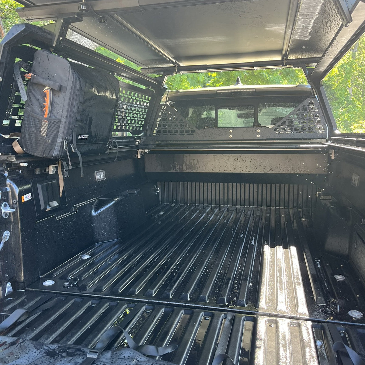 Workspace Field Bag hanging from a MOLLE bed rack panel under a truck cap