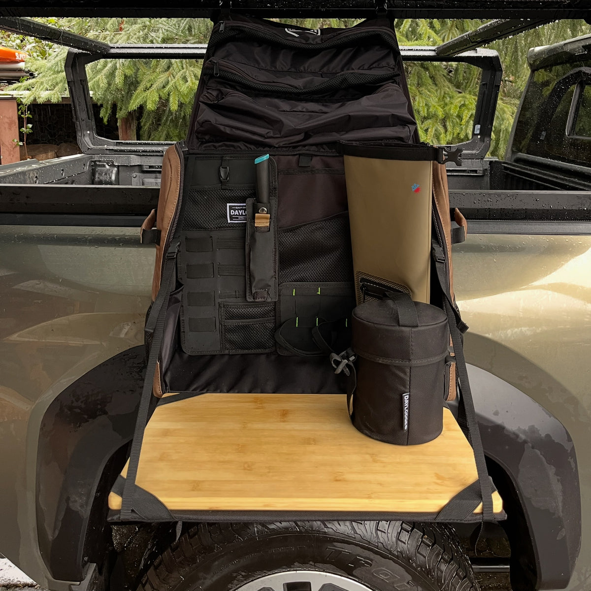 Workspace hanging open from a truck bed rack, bamboo board out