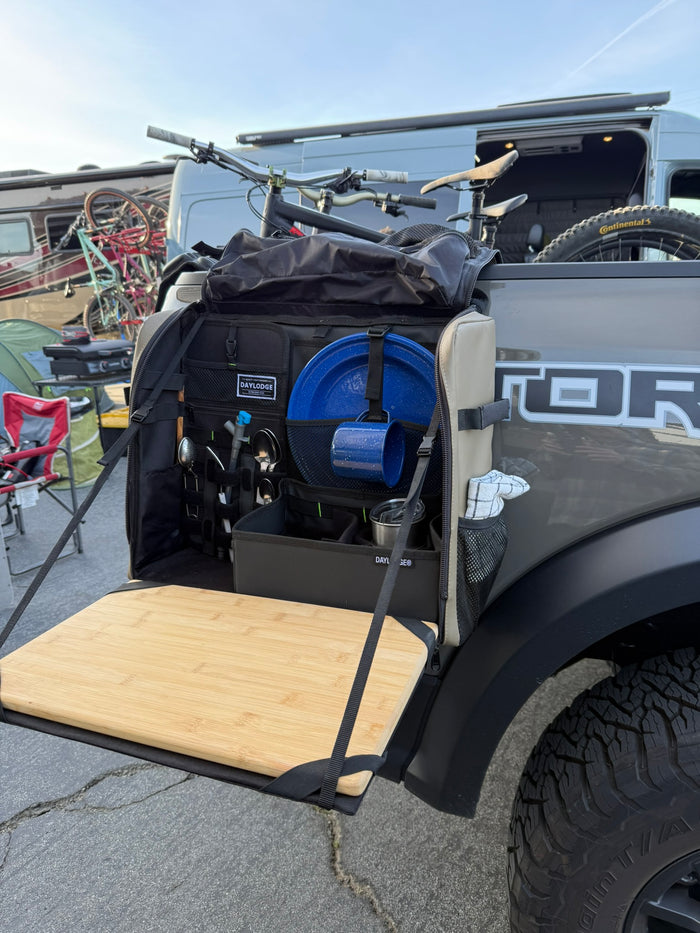 Workspace hanging open from the bed side of a Ford Raptor