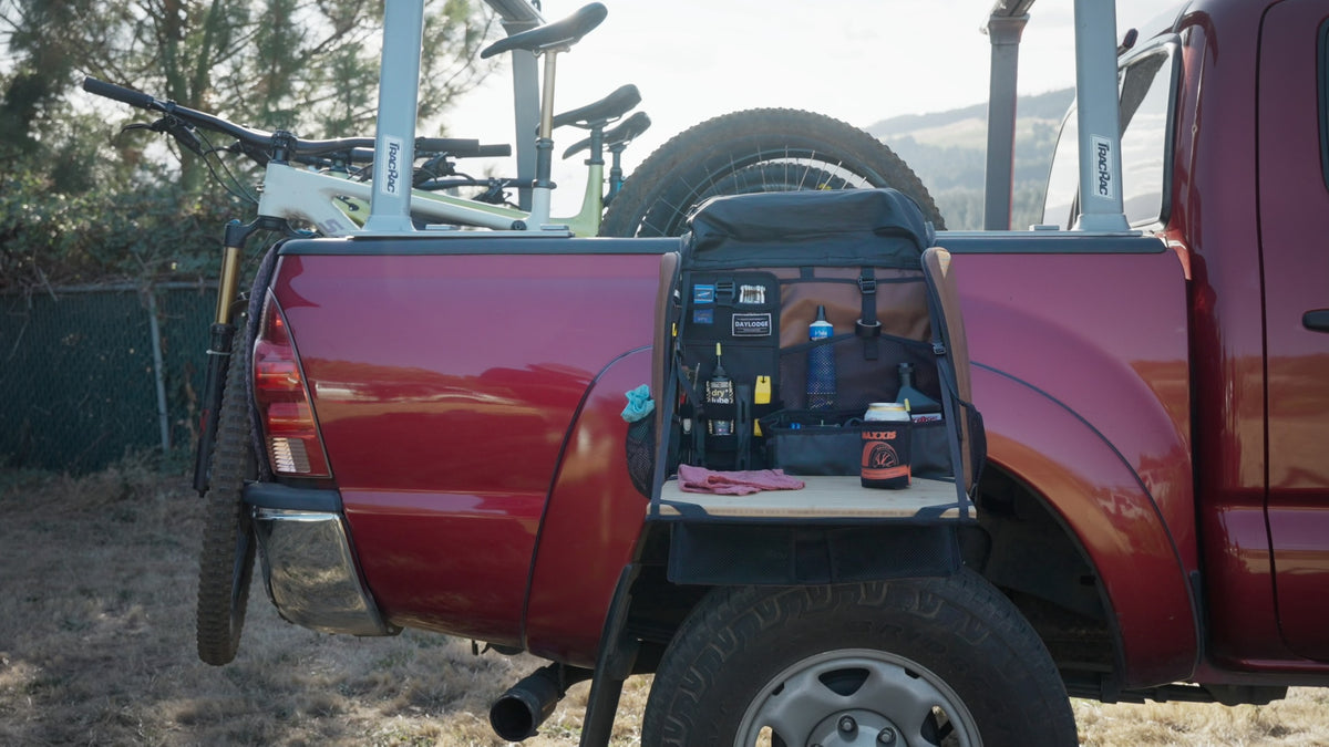Workspace hanging from a truck bed side as a bike tool station