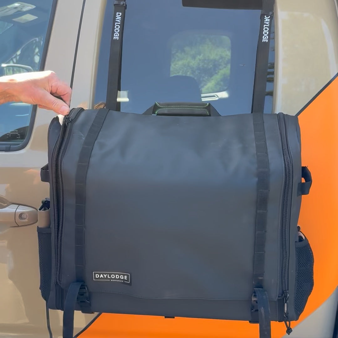 Workspace hanging from the top of an open truck door on flat-hook to G-hook straps