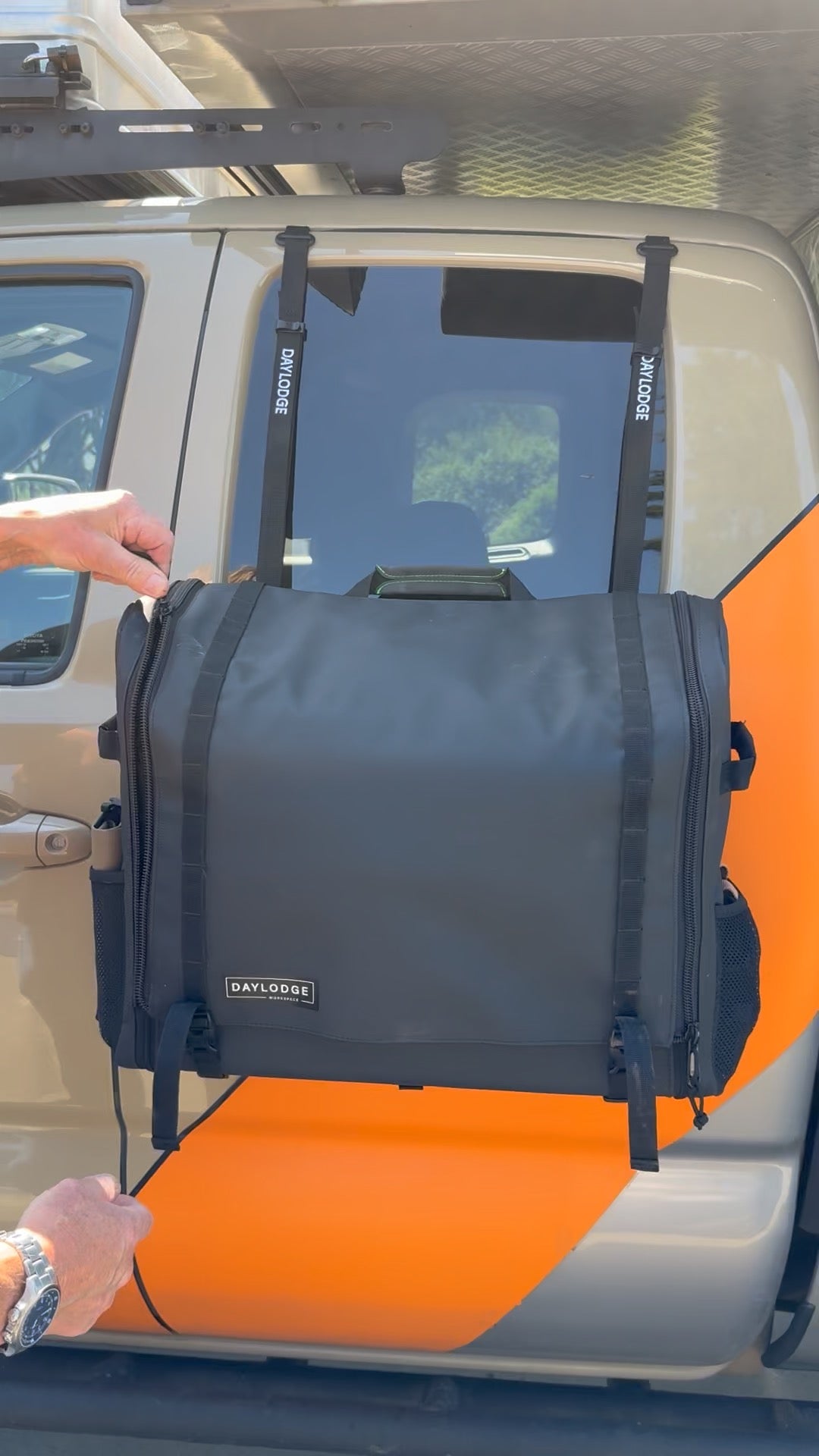 Workspace hanging from the top of an open truck door on flat-hook to G-hook straps