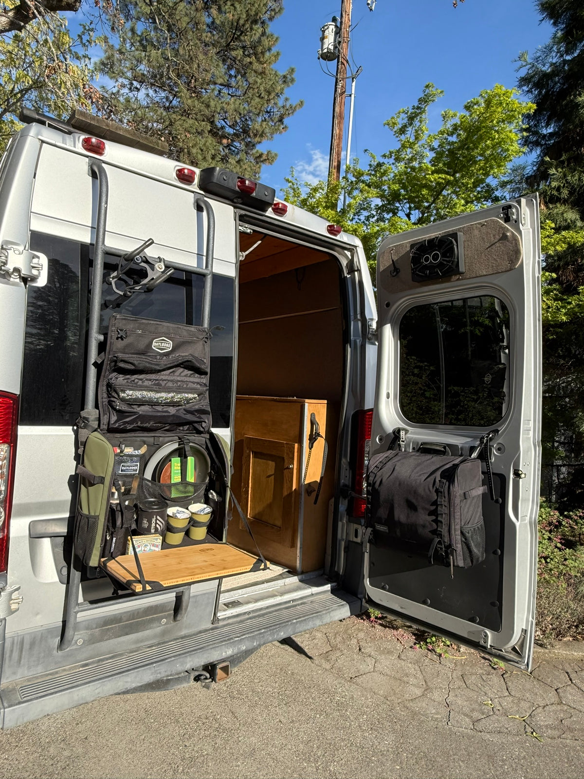 Workspace hanging open from the rear ladder of a Ram ProMaster van