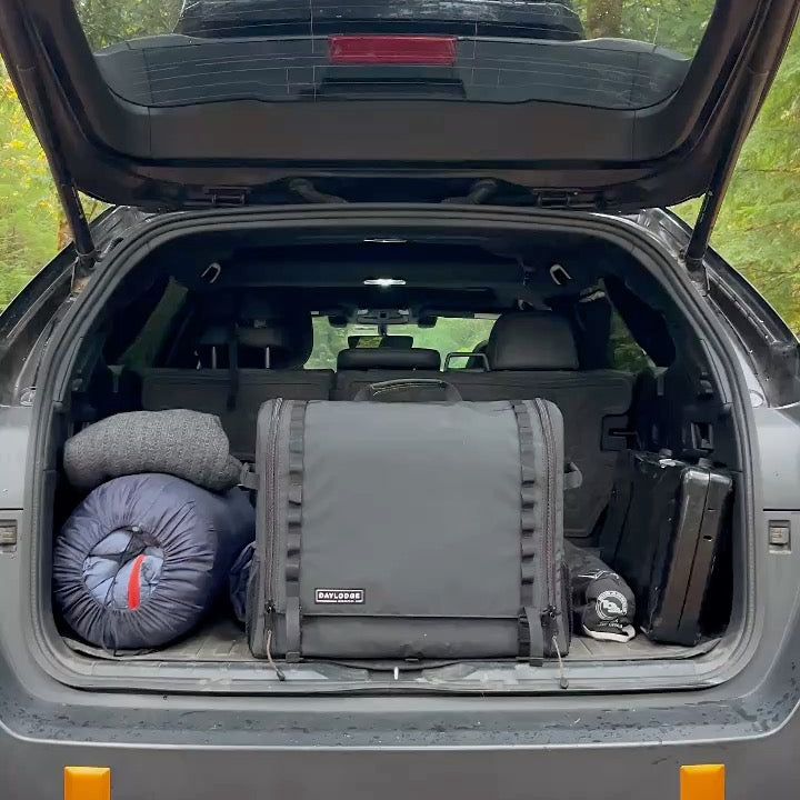 Workspace packed in the cargo area of a Subaru with camping gear