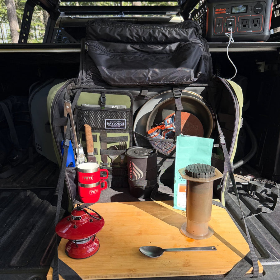 Workspace coffee setup on a truck tailgate with an AeroPress and Jetboil