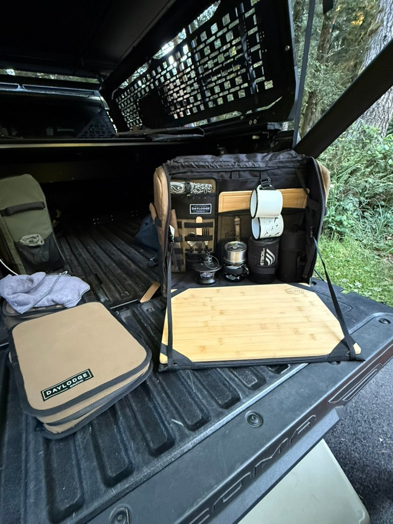 Workspace open on a Toyota Tacoma tailgate with a Gaucho case beside it